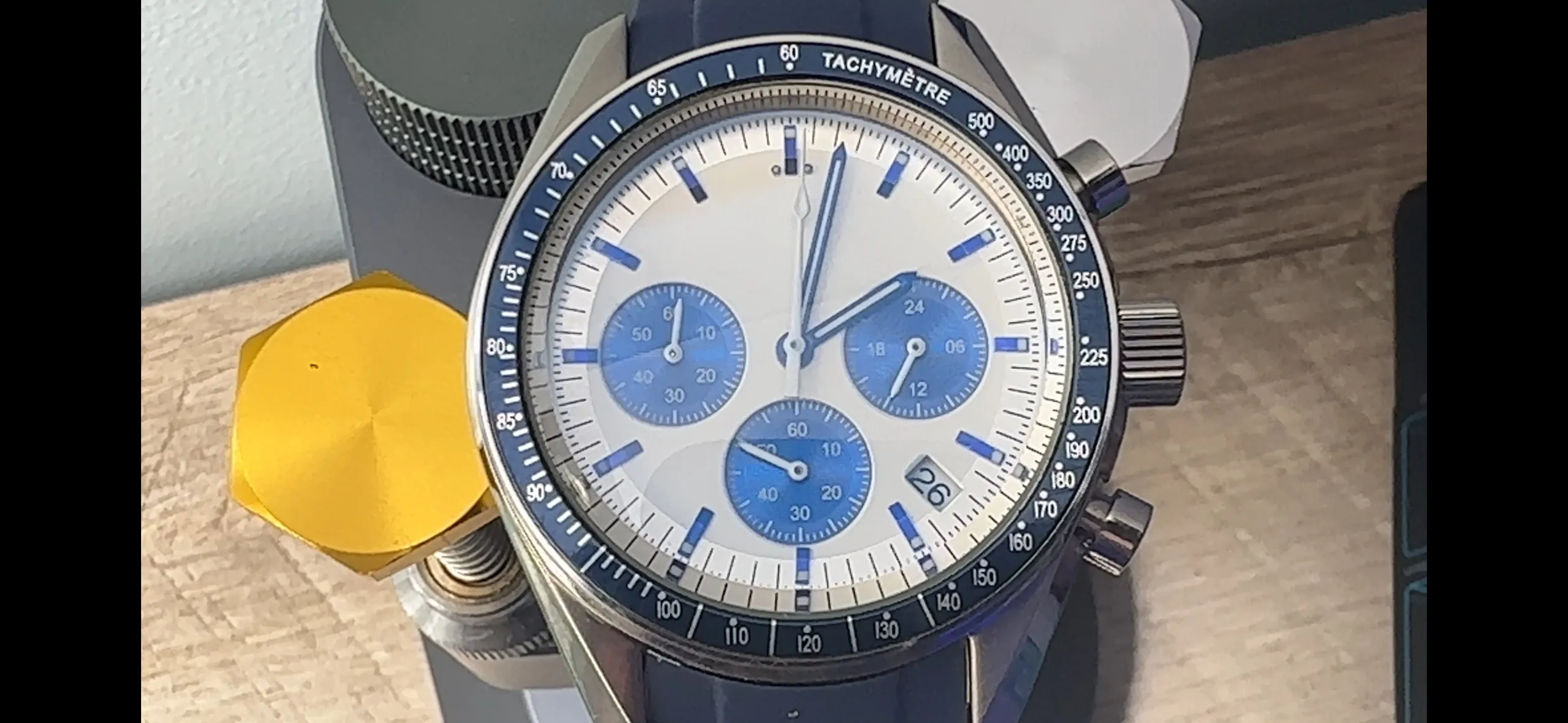 Close-up of the blue-and-white VK63 chronograph with blue subdials, tachymetre bezel and blue rubber strap